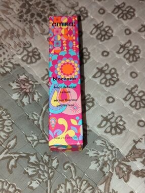 amika Heat Defense Serum in Bright Pink, Orange, Yellow & Blue Packaging